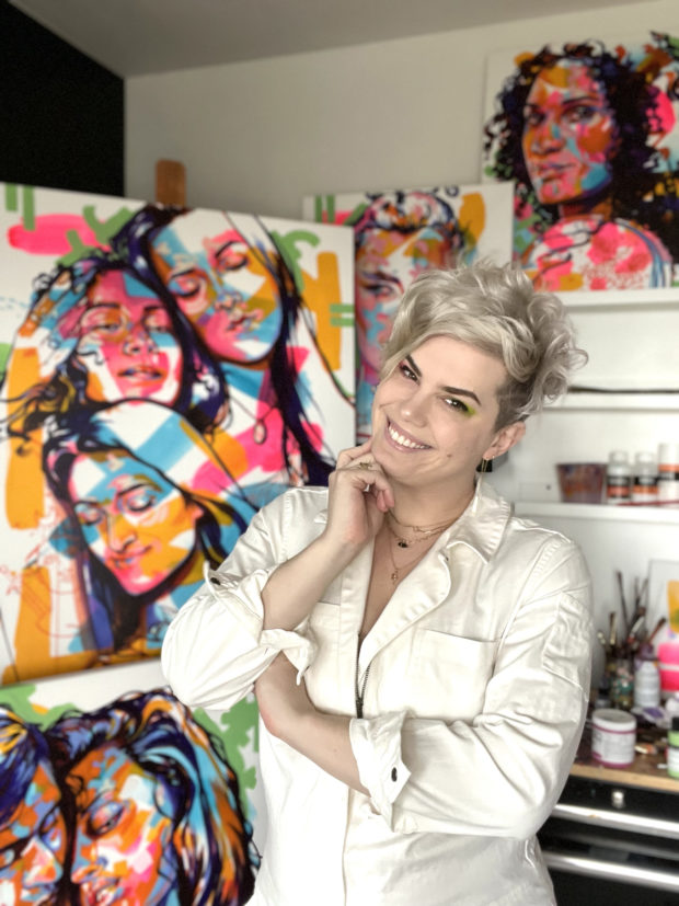 A picture of the artist The Tracy Piper in her studio, surrounded by her work.